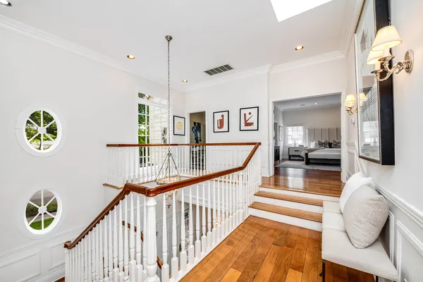 a view of a hallway with furniture and floor to ceiling window