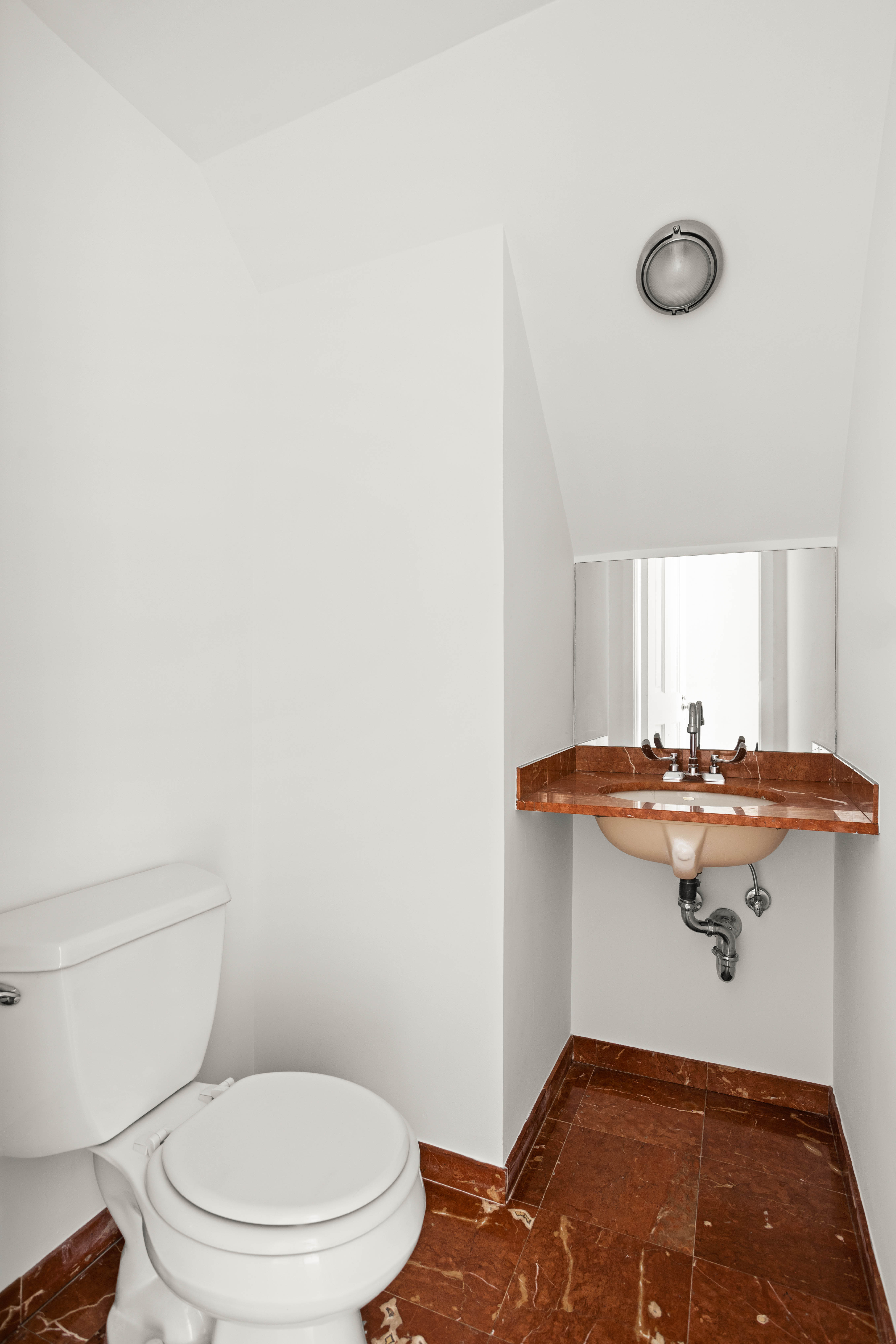 357 West 20th Street, Unit B Manhattan, NY 10011 - Photo 4 of 10 a bathroom with a sink a toilet and mirror