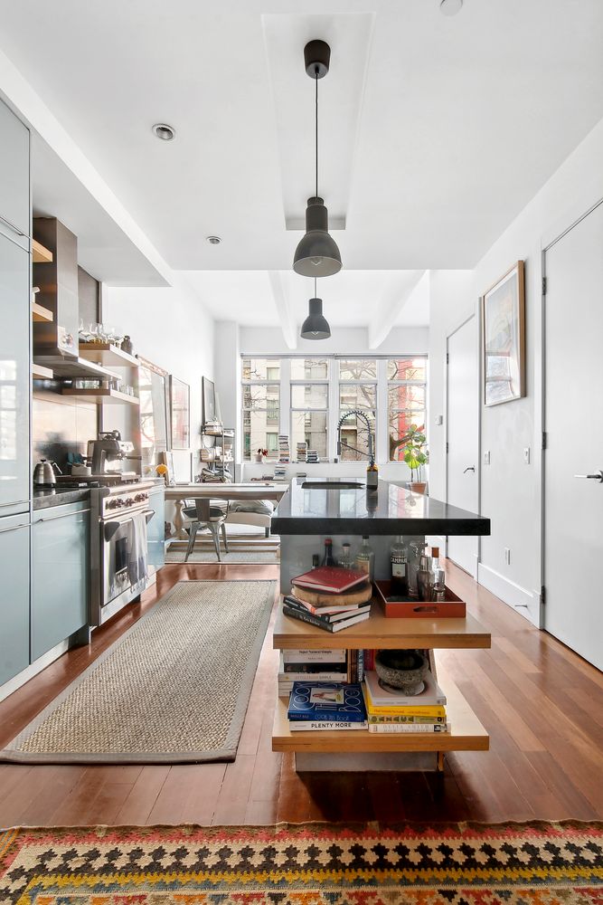 60 Broadway, Unit 2K Brooklyn, NY 11249 - Photo 2 of 7 a living room with lots of furniture and kitchen view