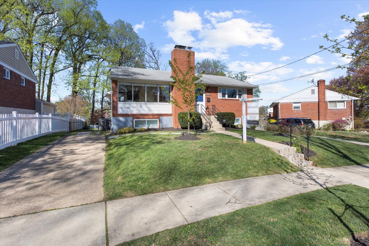 12712 Atherton Drive Silver Spring, MD 20906 - Photo 3 of 40 a front view of a house with a garden and yard