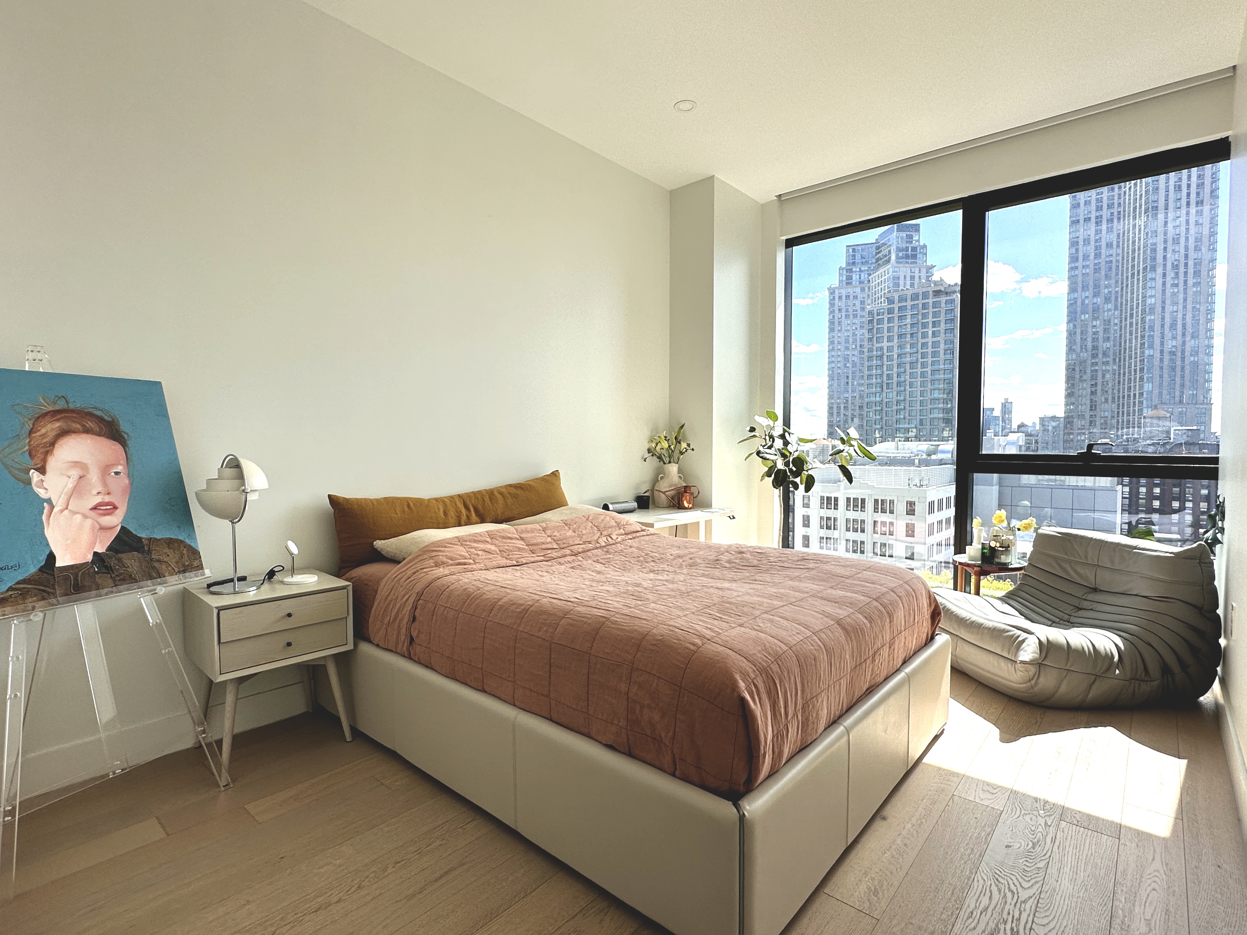 4507 Court Square West, Unit 10E Queens, NY 11101 - Photo 9 of 14 a bedroom with a bed and a large window