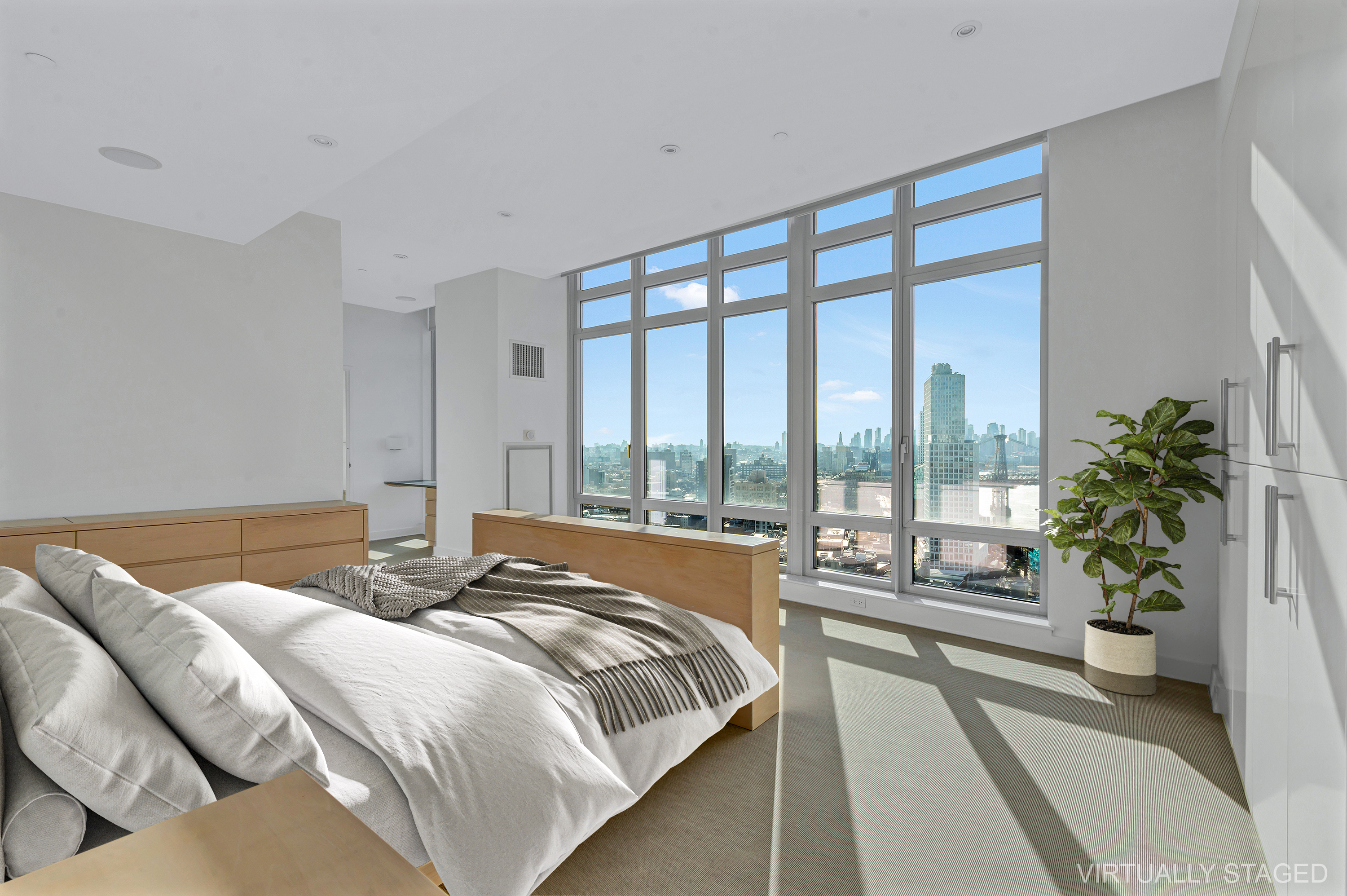 2 Northside Piers, Unit PH2 Brooklyn, NY 11249 - Photo 12 of 27 a bed sitting in a bedroom next to a large window