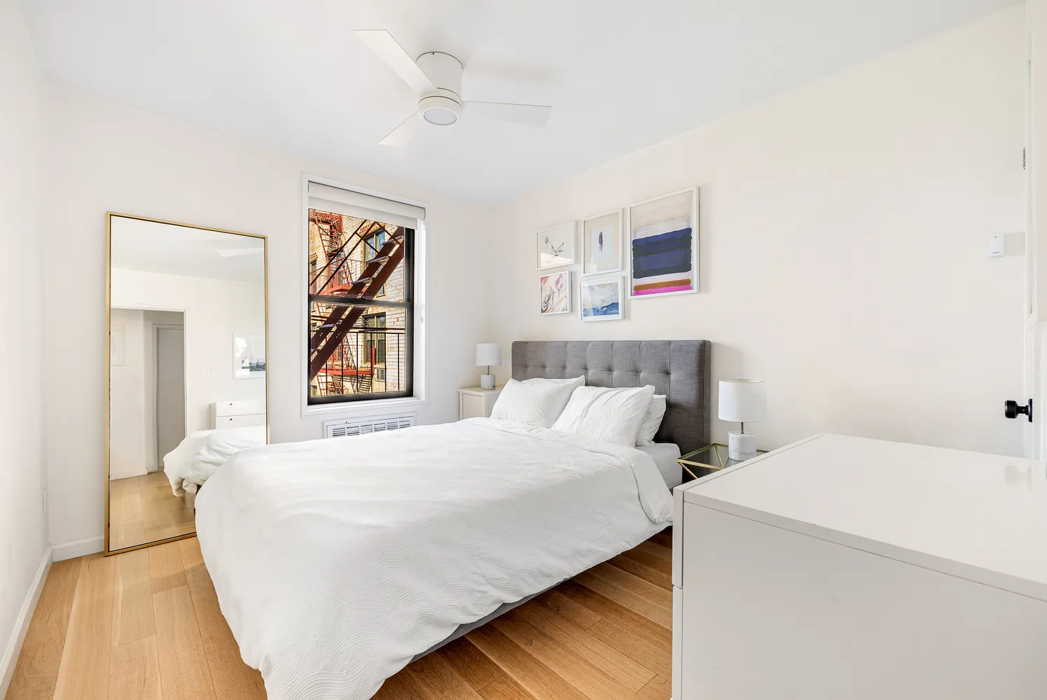 a bedroom with a bed and a painting on the wall