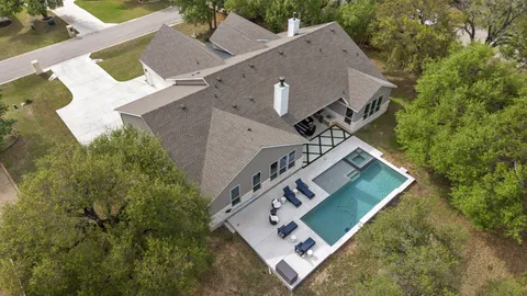 an aerial view of a house with garden space and street view