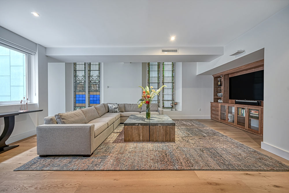 135 West 4th Street, Unit 3E Manhattan, NY 10012 - Photo 3 of 11 a living room with furniture and a flat screen tv