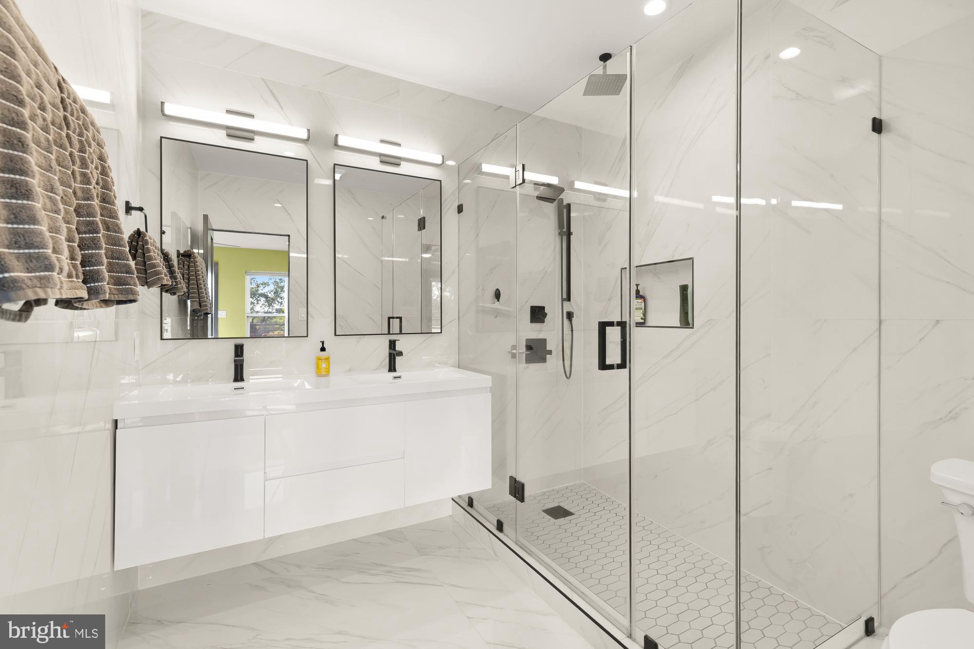 47 T Street Northeast Washington, DC 20002 - Photo 32 of 45 a bathroom with a double vanity sink mirror and shower