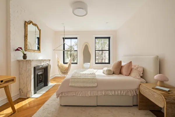 a bedroom with bed and a fireplace