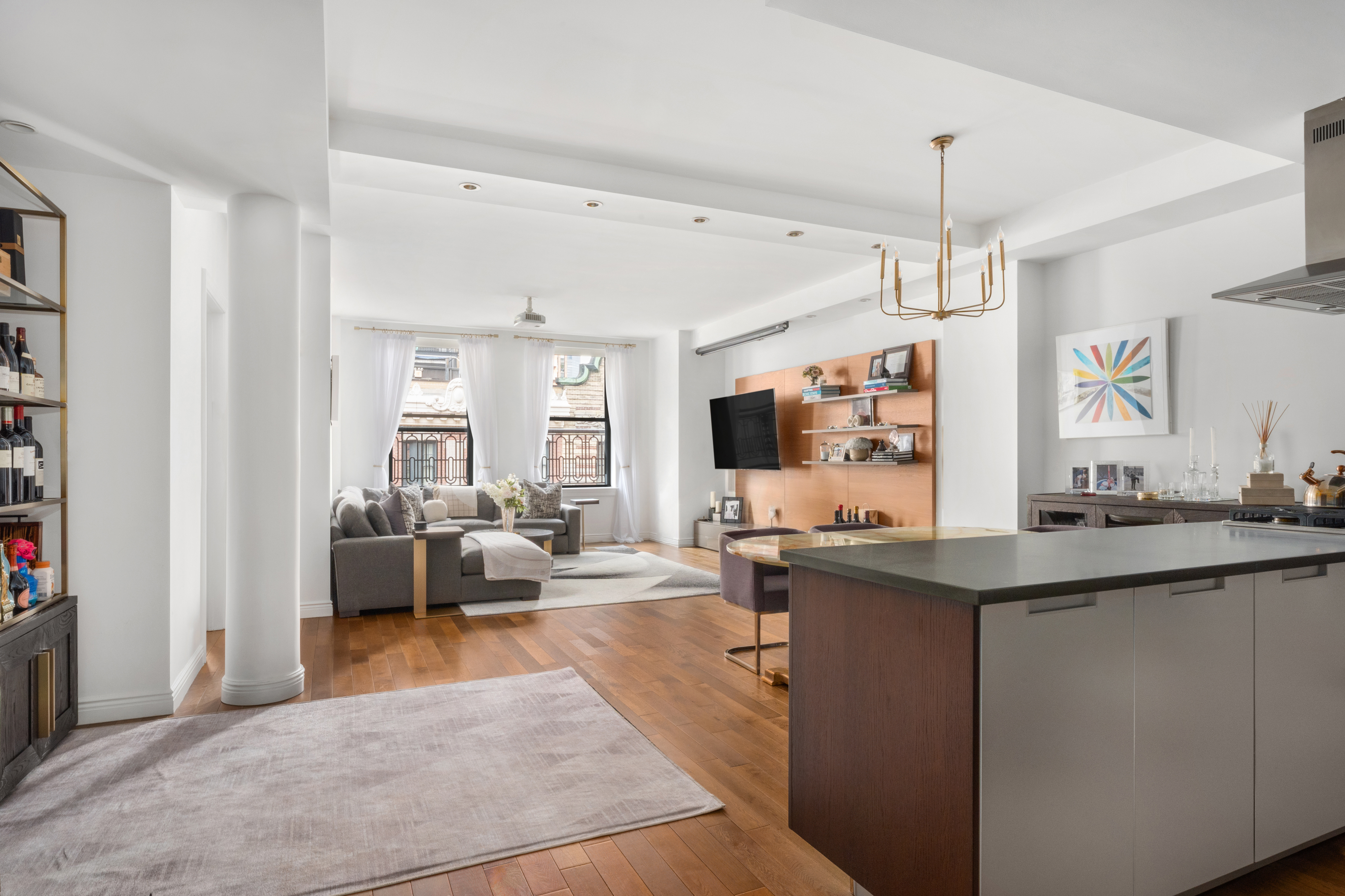 225 5th Avenue, Unit 11A Manhattan, NY 10010 - Photo 2 of 13 a living room with kitchen island furniture and a flat screen tv
