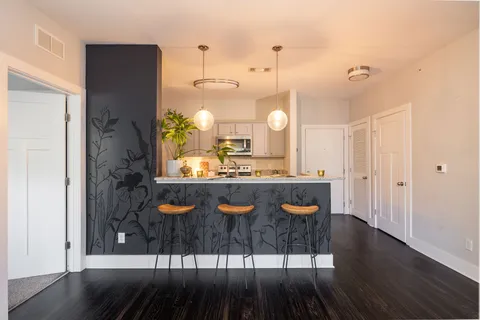 a bathroom with granite countertop a sink a vanity and a large mirror