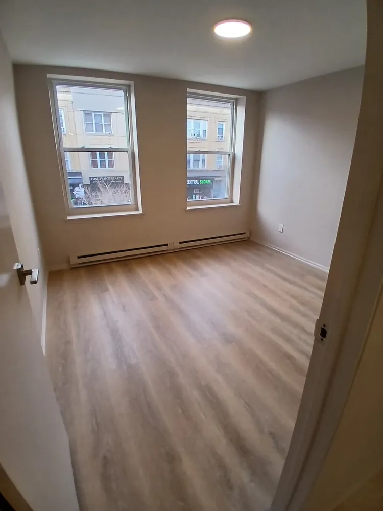 wooden floor in an empty room with windows