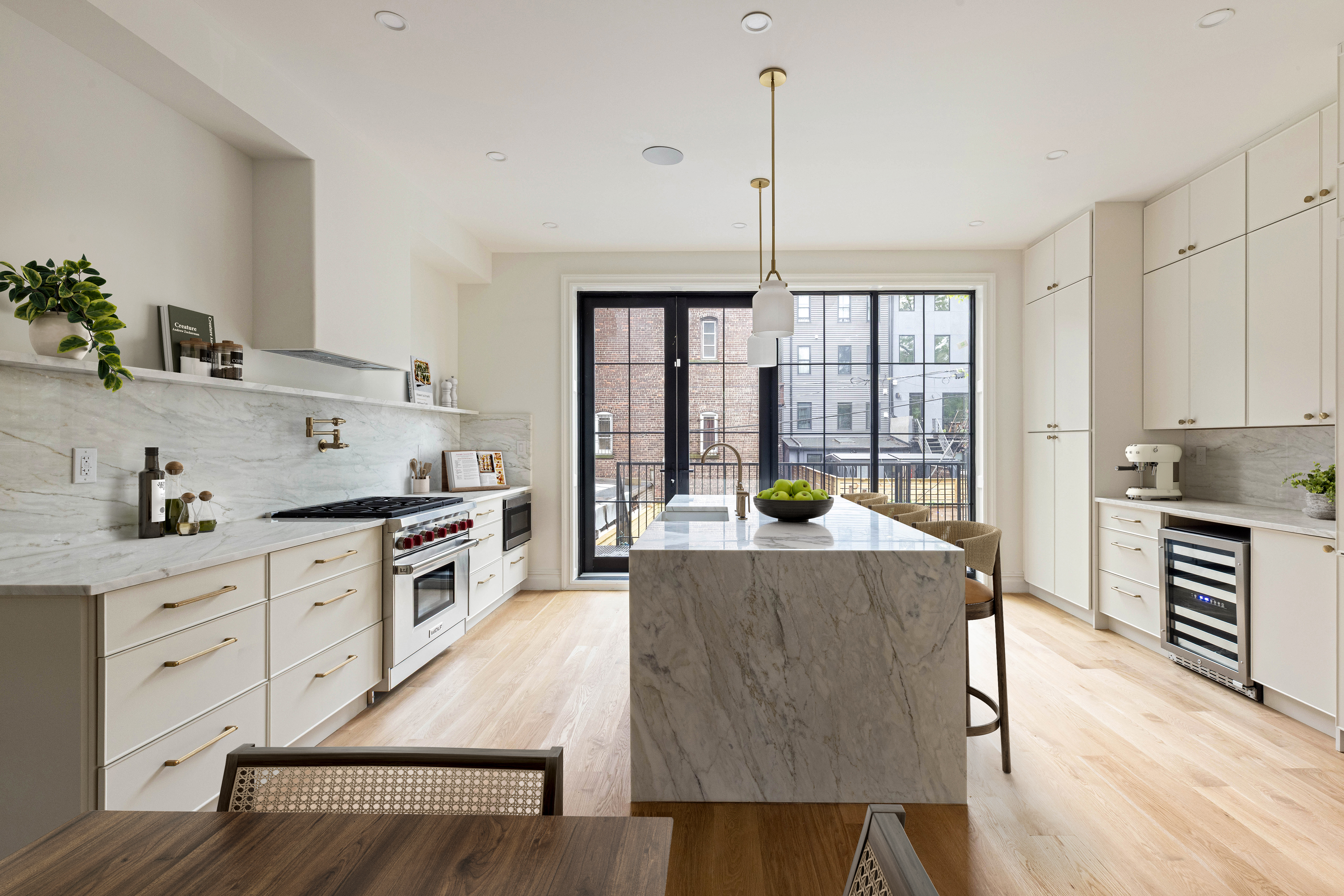 318 Halsey Street Brooklyn, NY 11216 - Photo 4 of 16 a open kitchen with granite countertop a stove a sink dishwasher a refrigerator and white cabinets with wooden floor