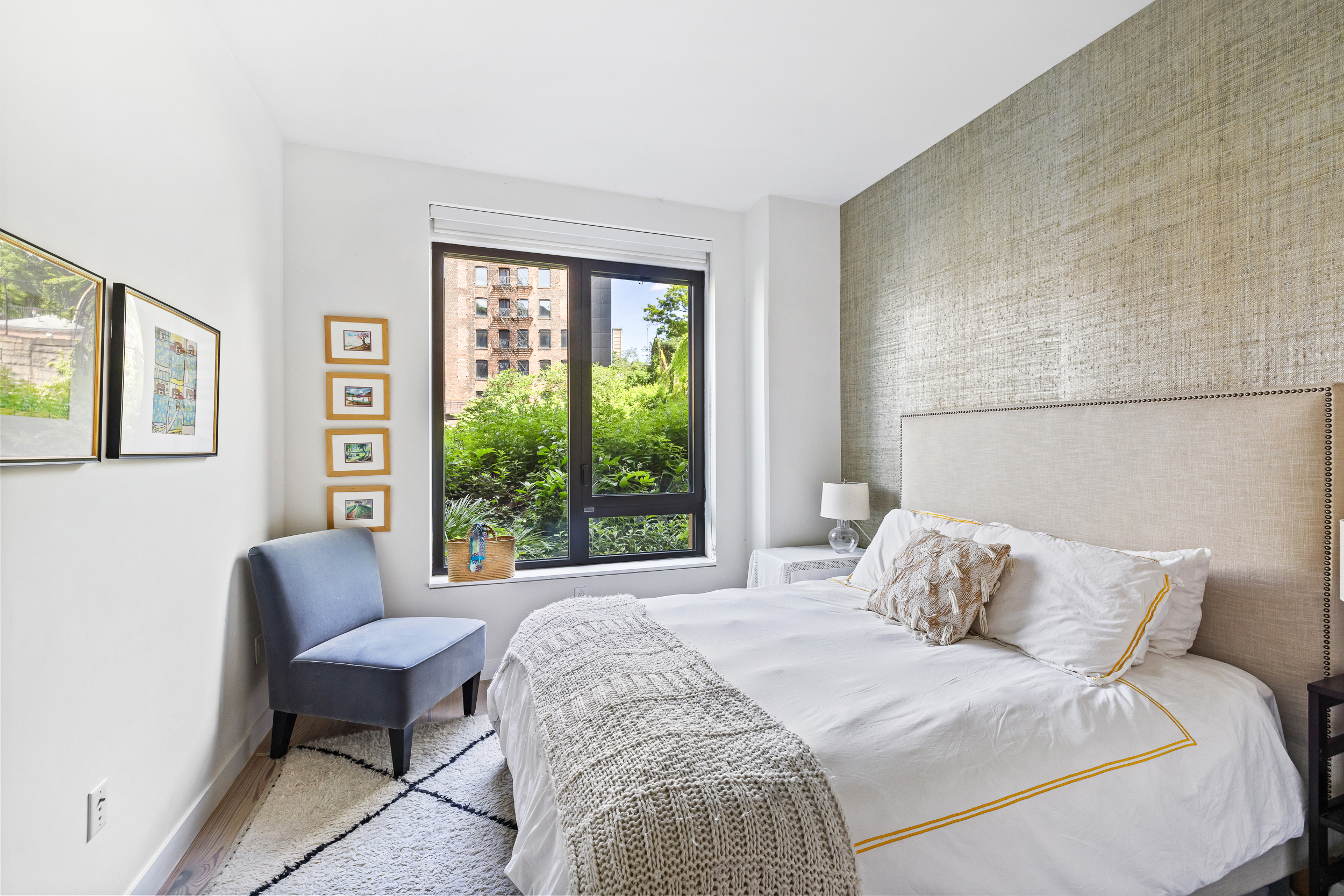 90 Furman Street, Unit N107 Brooklyn, NY 11201 - Photo 14 of 30 a bedroom with a bed chair and a large window