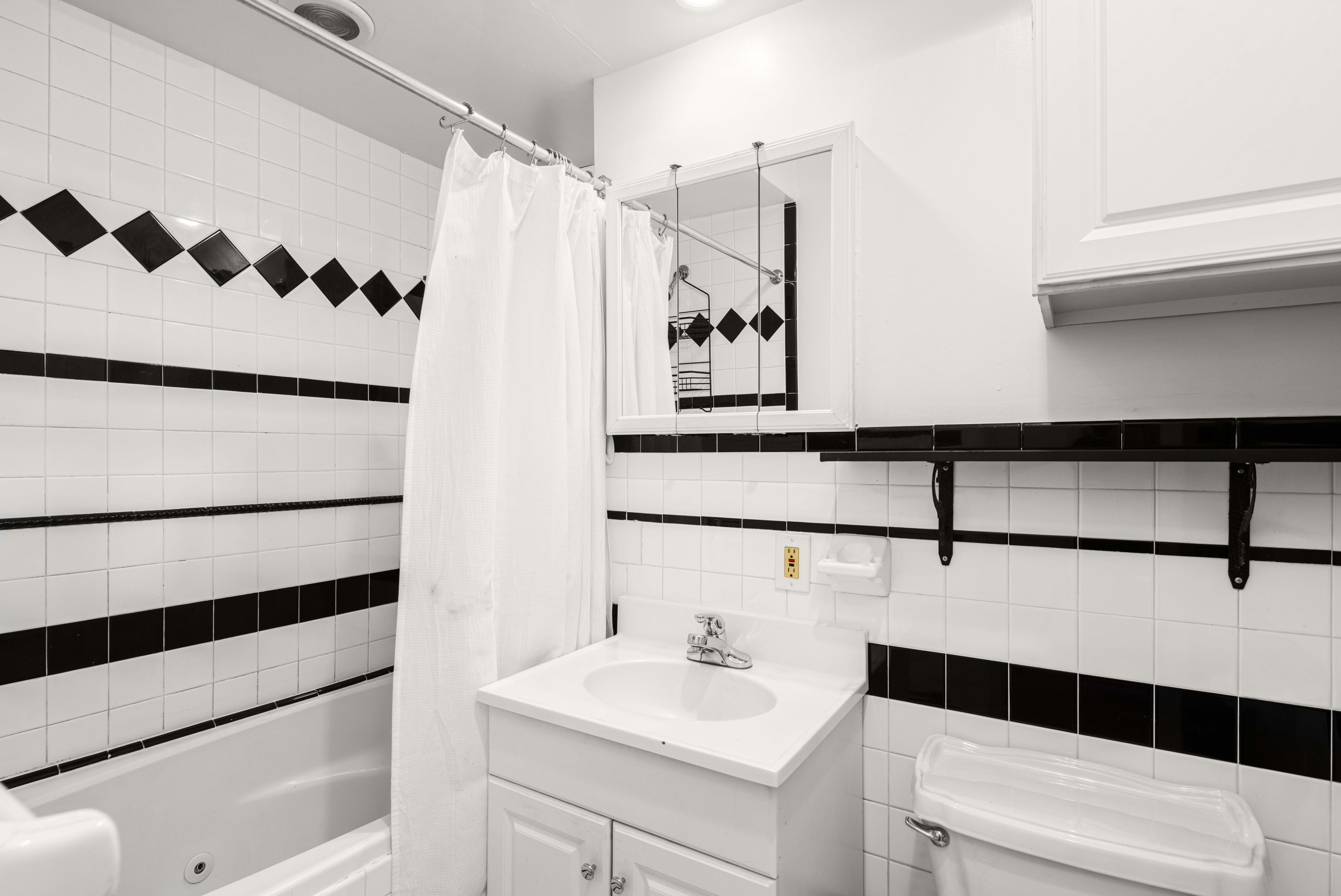 120 Suffolk Street, Unit 5B Manhattan, NY 10002 - Photo 9 of 14 a bathroom with a sink and a mirror