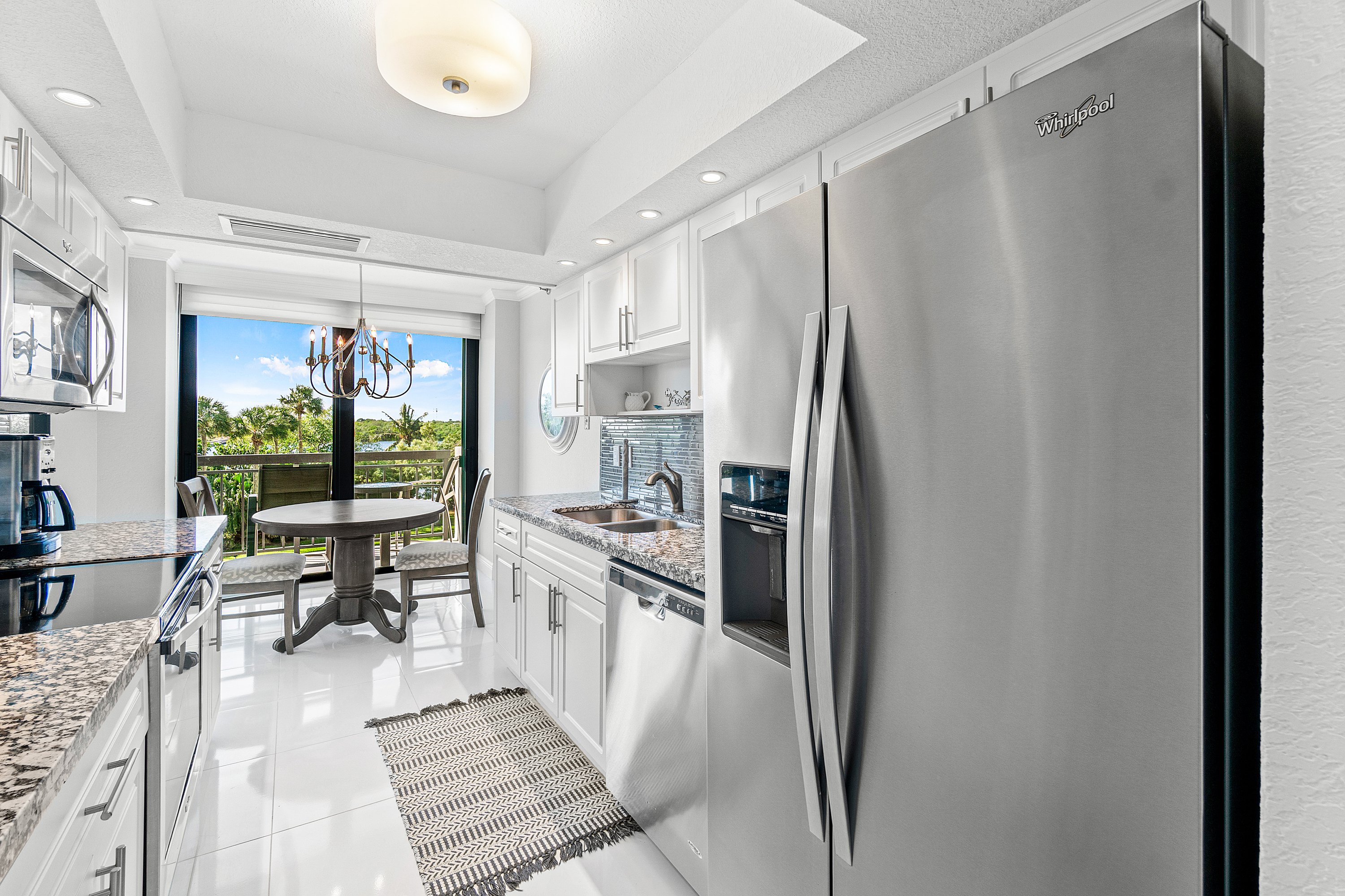 2003 North Ocean Boulevard, Unit 305 Boca Raton, FL 33431 - Photo 34 of 56 a kitchen with stainless steel appliances granite countertop a refrigerator and a sink