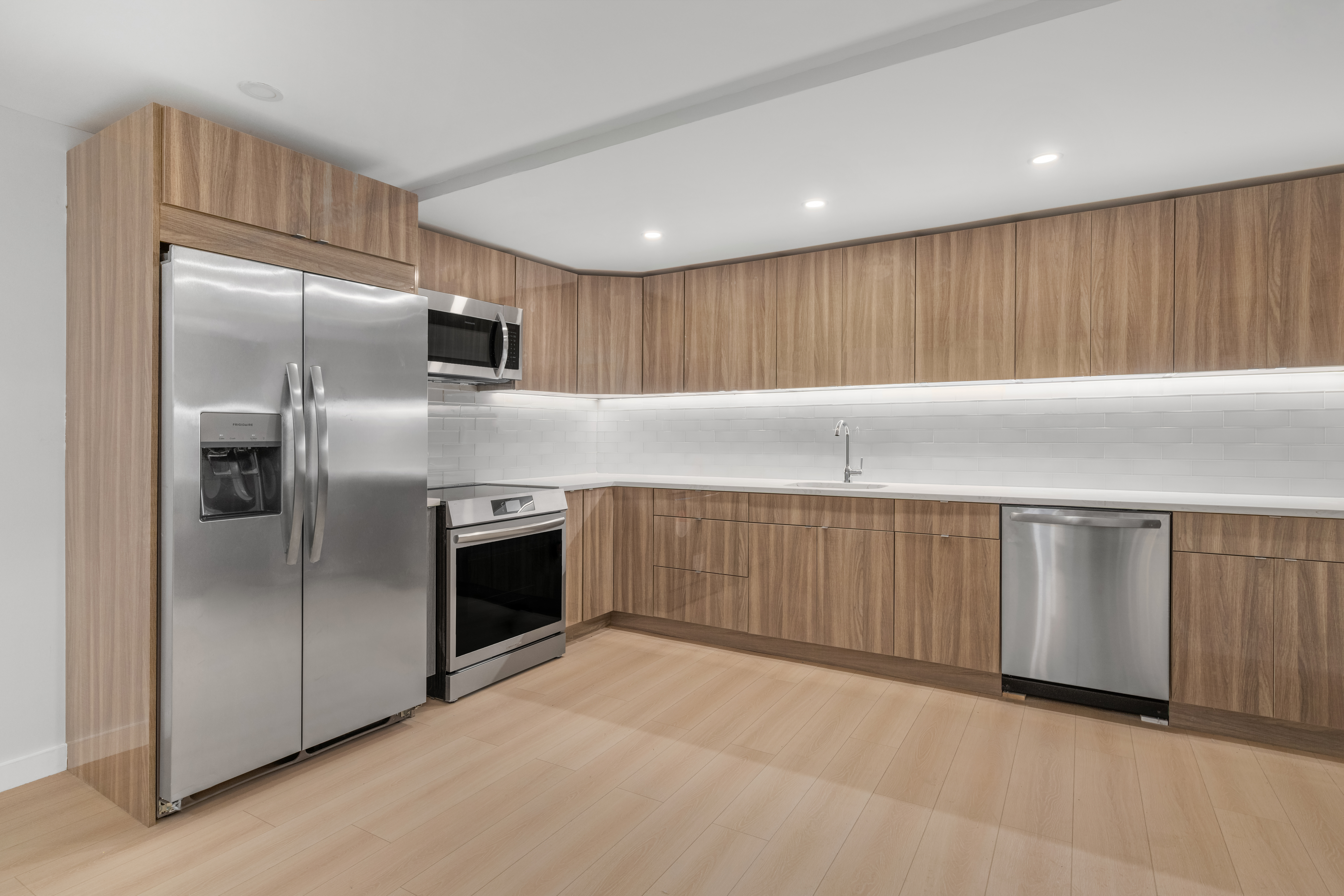 227 East 21st Street, Unit 2R Manhattan, NY 10010 - Photo 2 of 12 a kitchen with white cabinets