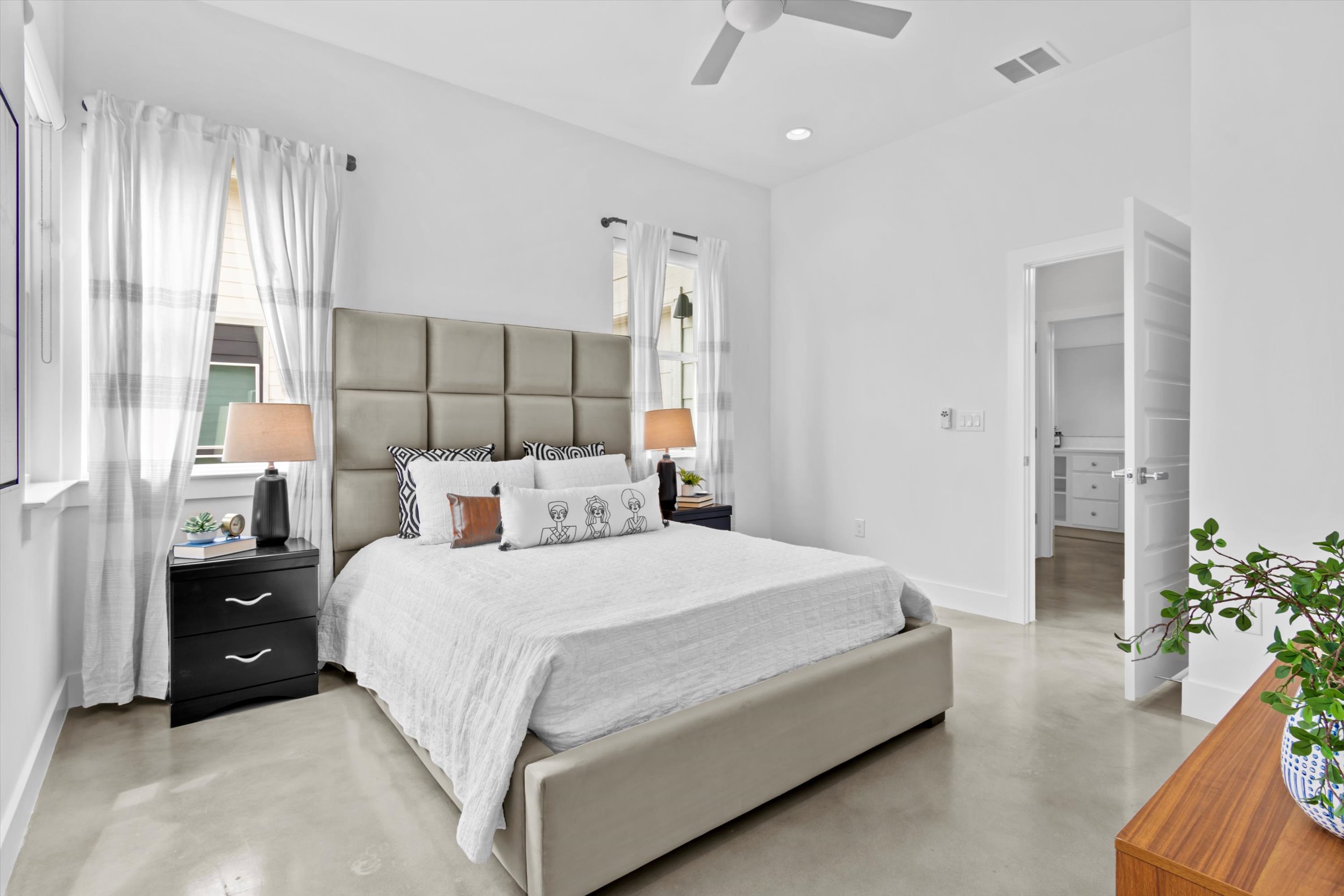 513 West Croslin Street, Unit A Austin, TX 78752 - Photo 17 of 39 a bedroom with a large bed and a potted plant