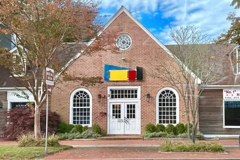 a view of a large brick building next to a yard