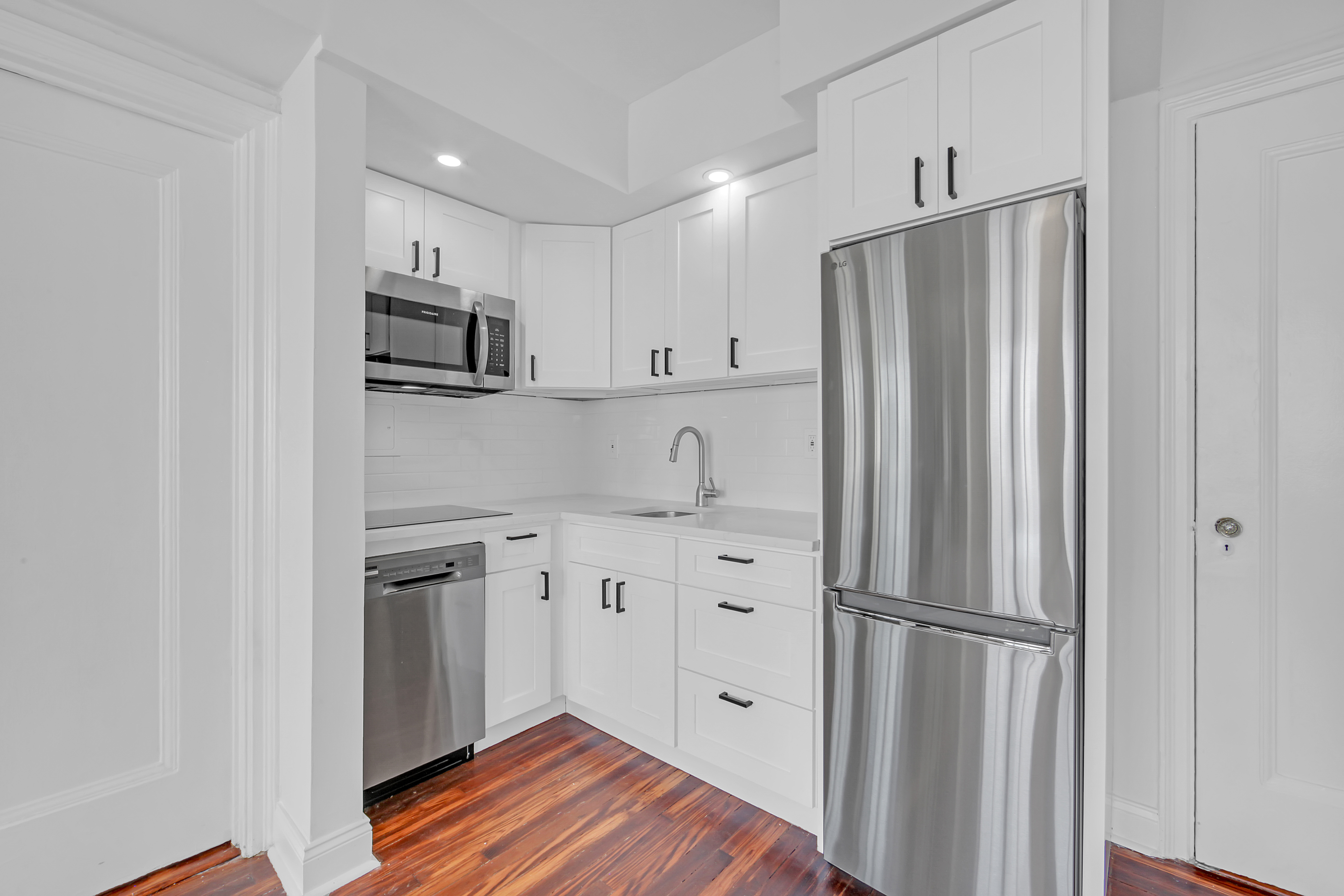 5 Tudor City Place, Unit 625 Manhattan, NY 10017 - Photo 5 of 11 a kitchen with stainless steel appliances a refrigerator sink and microwave