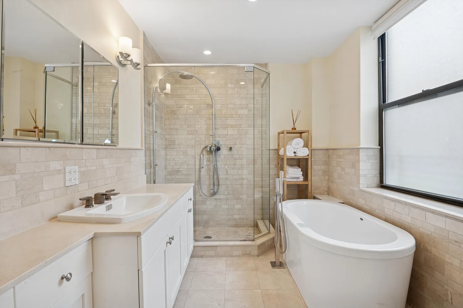 a bathroom with a bathtub shower sink mirror and toilet