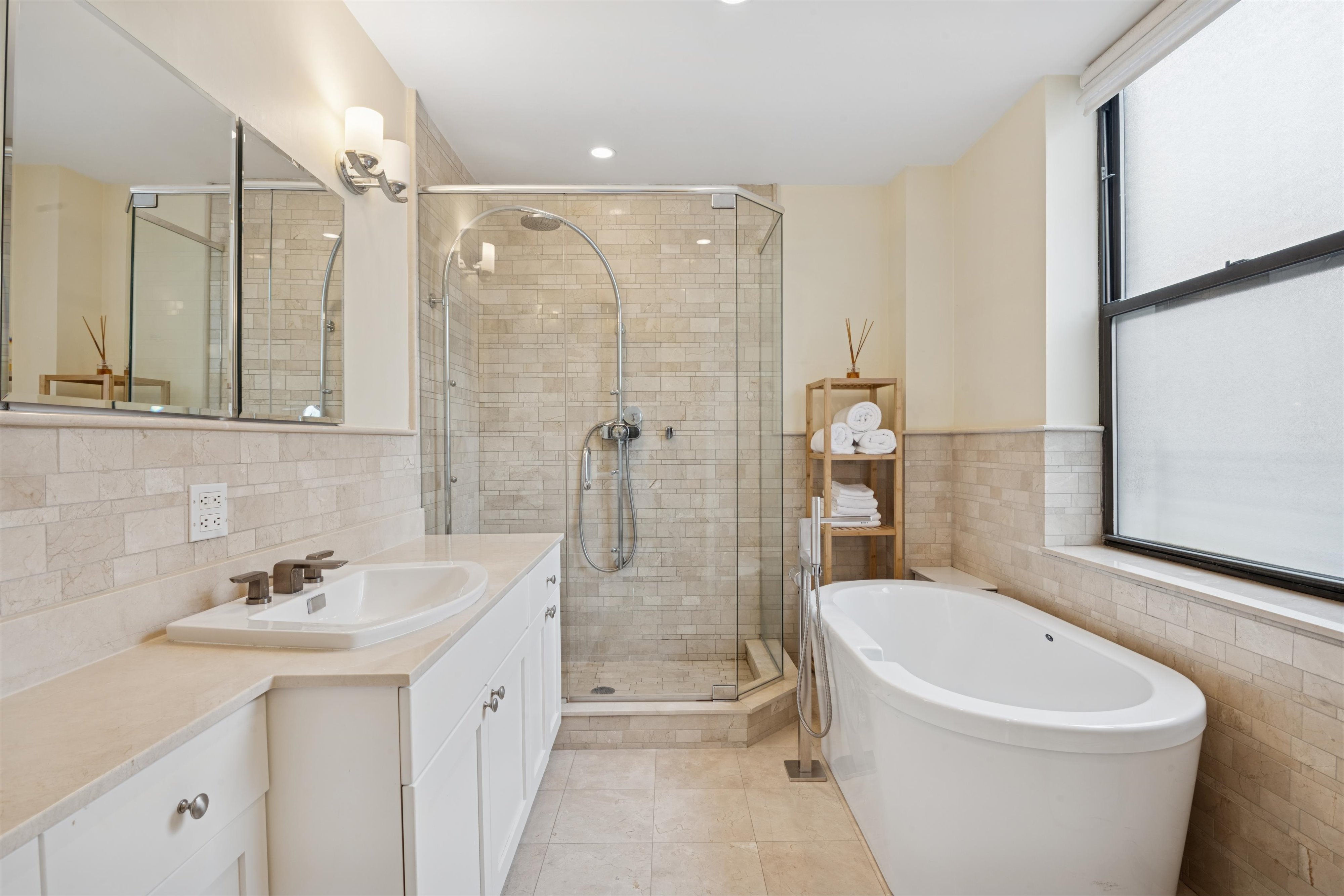 514 West End Avenue, Unit 8/9A Manhattan, NY 10024 - Photo 20 of 24 a bathroom with a bathtub shower sink mirror and toilet