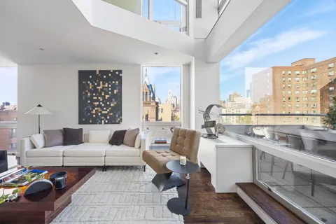 a living room with furniture a large window and a table