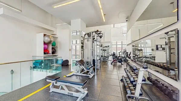 a gym room with lots of gym equipment