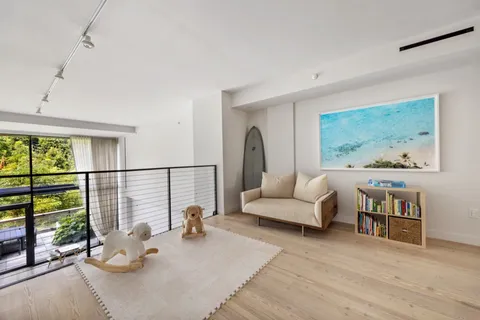 a living room with furniture and a floor to ceiling window