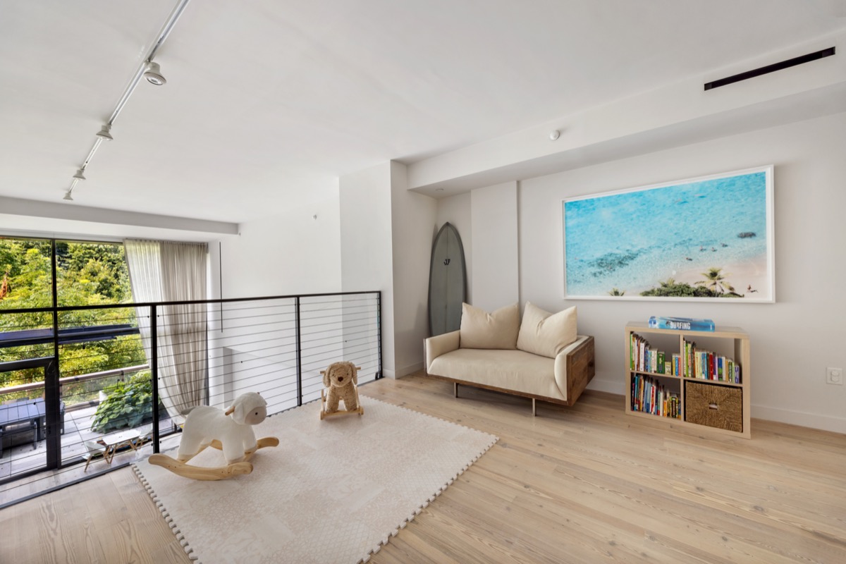 90 Furman Street, Unit N208 Brooklyn, NY 11201 - Photo 12 of 23 a living room with furniture and a floor to ceiling window