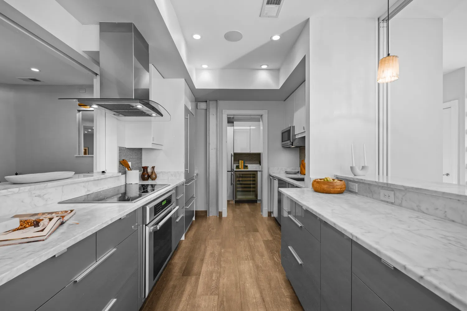 a large kitchen with stainless steel appliances granite countertop a lot of counter space and wooden floor