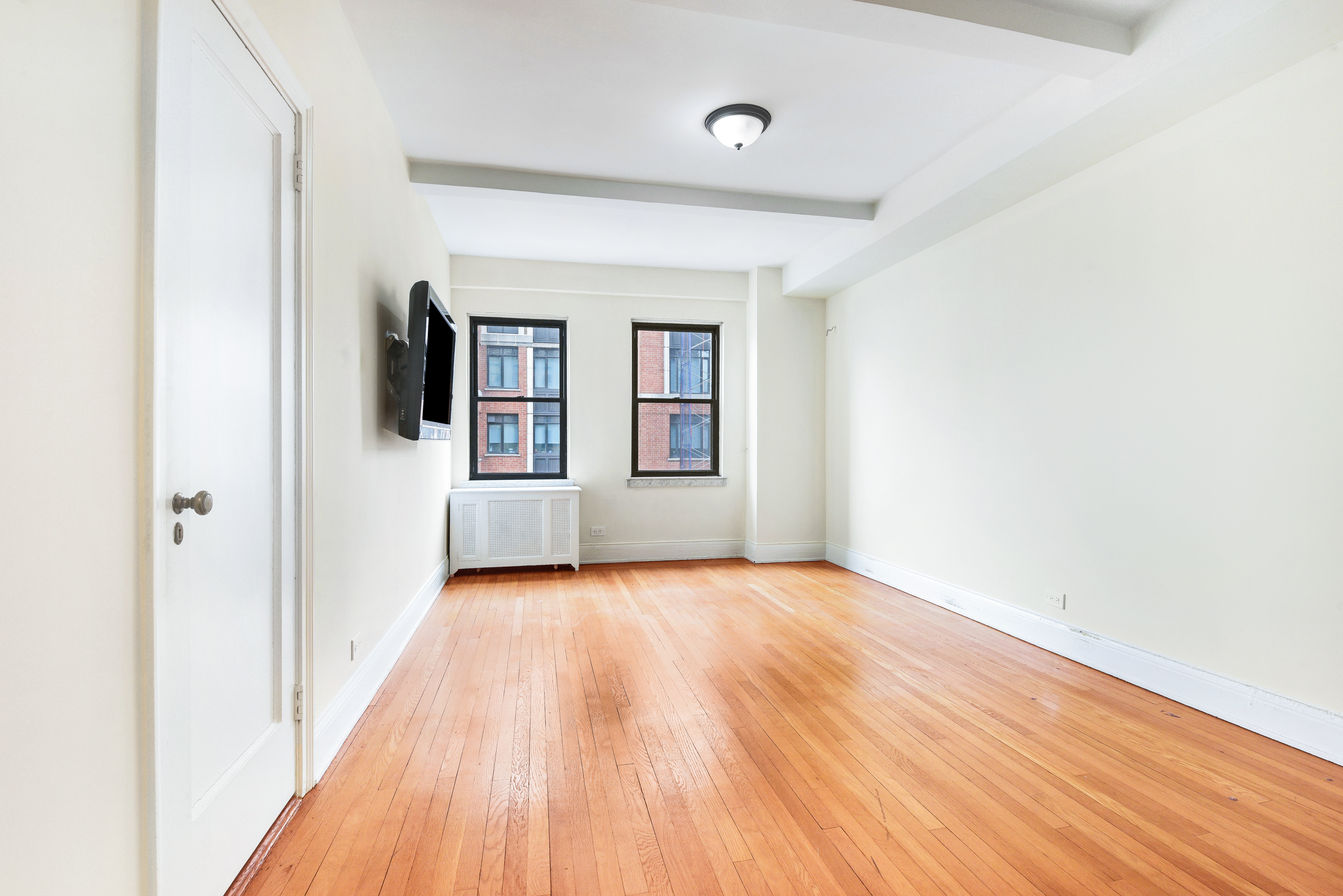 49 East 96th Street, Unit 8/9E Manhattan, NY 10128 - Photo 12 of 17 a view of a house with wooden floor and windows