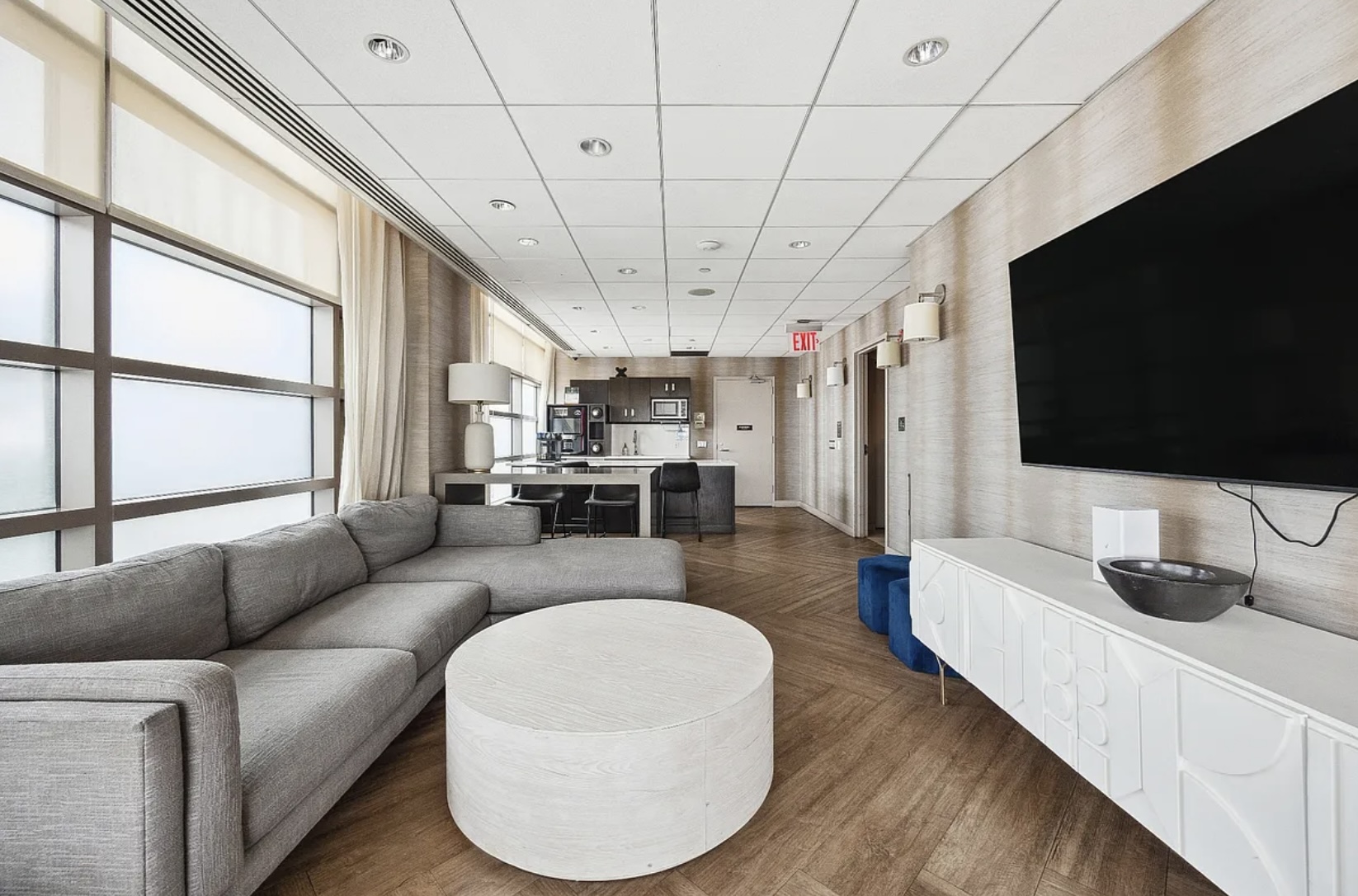 215-217 East 96th Street, Unit 26F Manhattan, NY 10128 - Photo 16 of 19 a living room with stainless steel appliances furniture and a flat screen tv