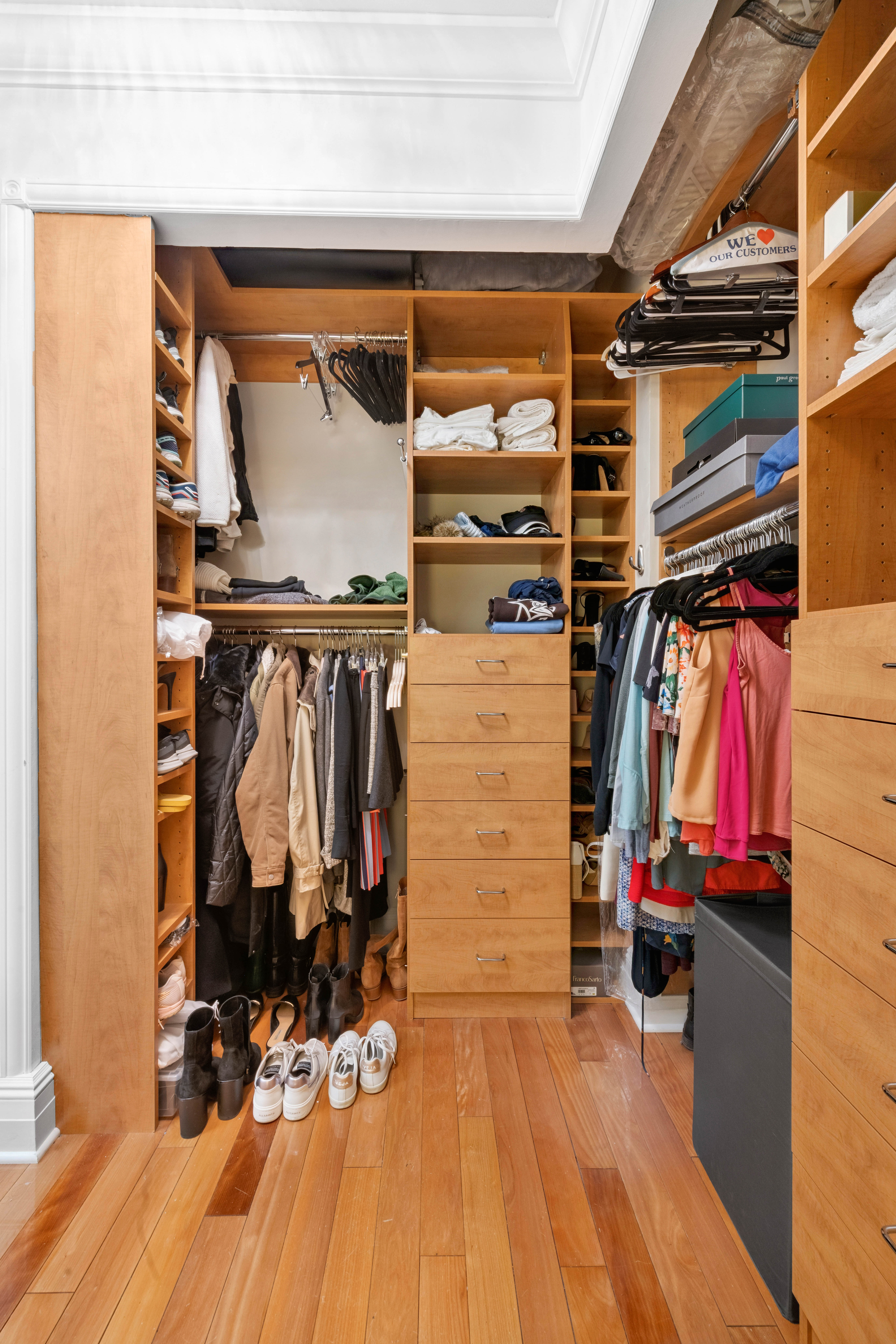 200 East 69th Street, Unit 4N Manhattan, NY 10021 - Photo 4 of 13 a view of walk in closet with clothes and shoes