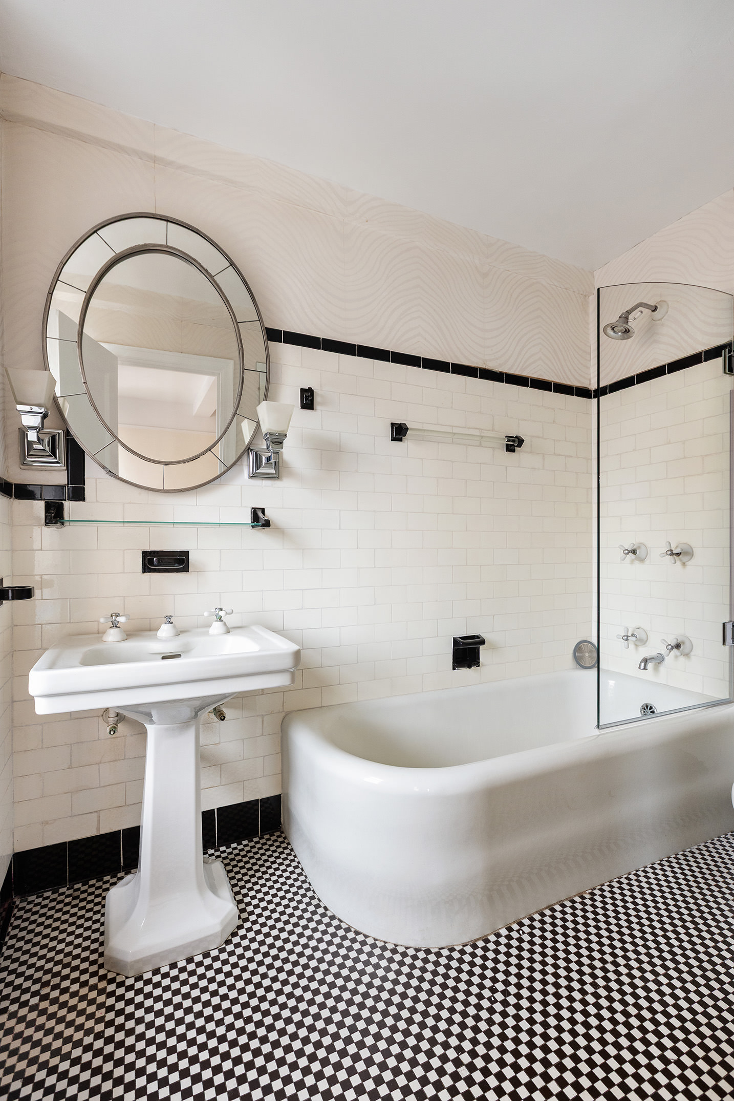205 East 78th Street, Unit 14C Manhattan, NY 10075 - Photo 5 of 12 a bathroom with a sink a mirror and a shower