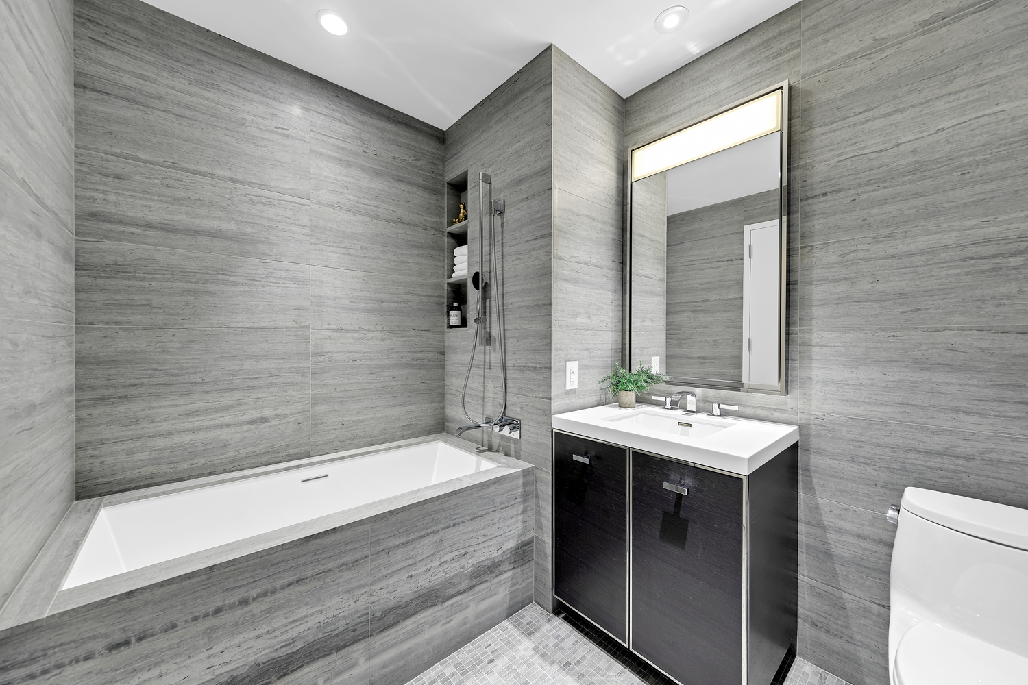 252 South Street, Unit 53E Manhattan, NY 10002 - Photo 6 of 17 a bathroom with a sink and a bathtub