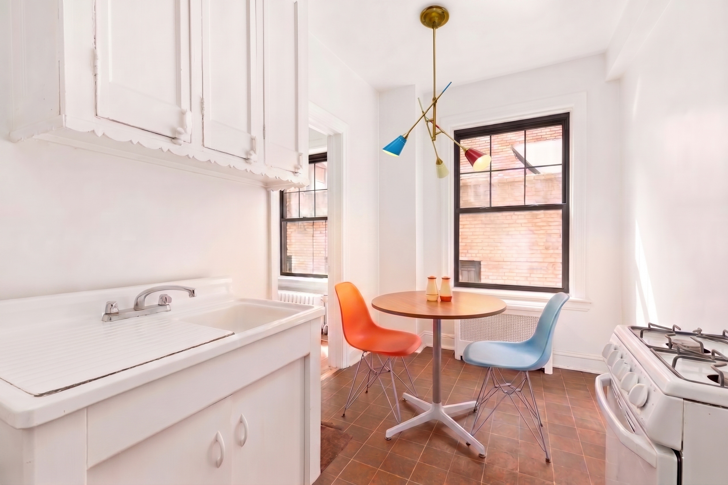 170 2nd Avenue, Unit 3E Manhattan, NY 10003 - Photo 5 of 12 a room with table chairs and windows