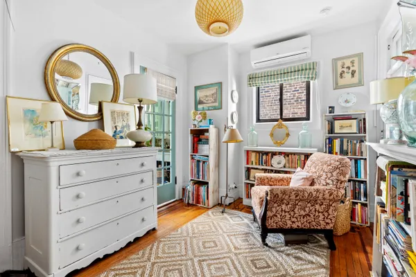 a bed room with a bed and a painting on the wall