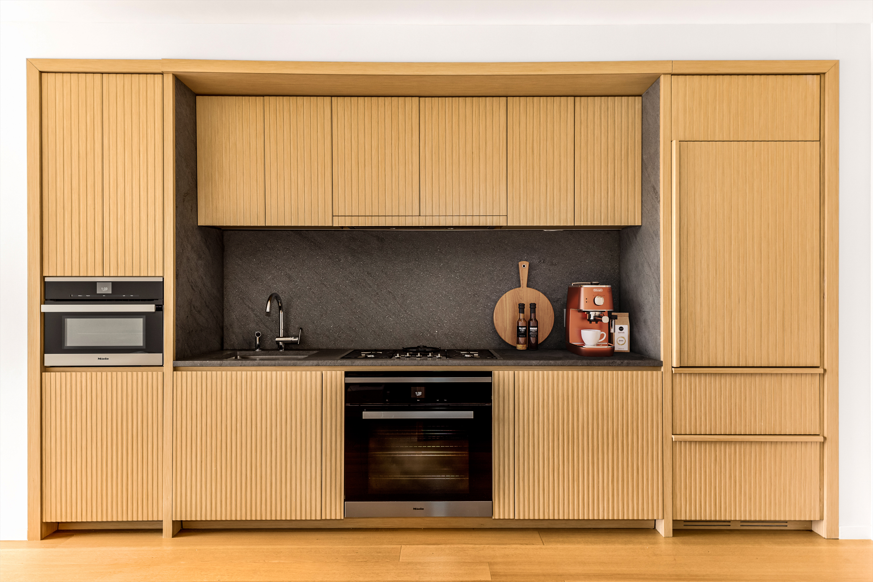 565 Broome Street, Unit S9A Manhattan, NY 10013 - Photo 4 of 19 a kitchen with stainless steel appliances granite countertop a refrigerator and a stove