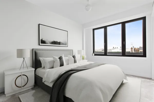 a bedroom with a large bed and a large window