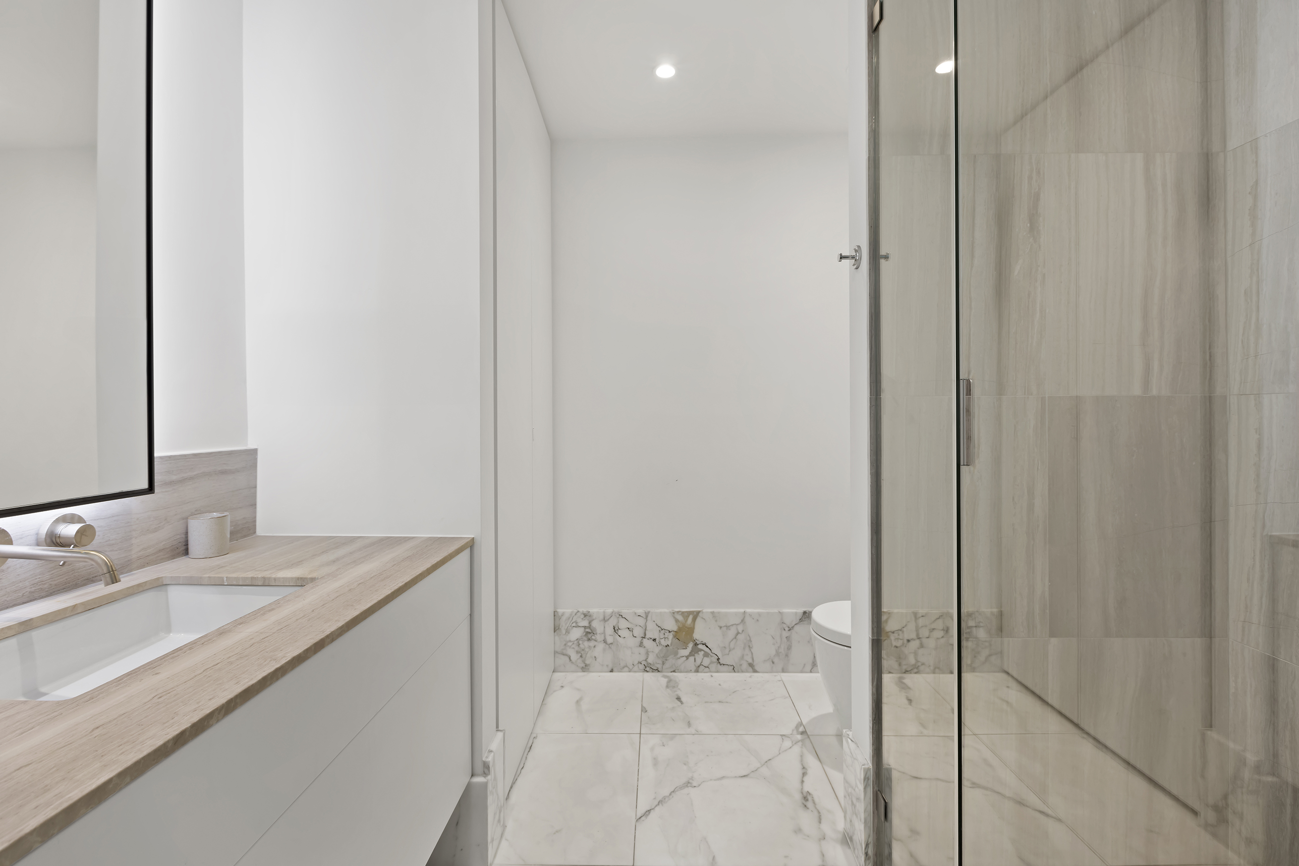 429 Kent Avenue, Unit TH2 Brooklyn, NY 11249 - Photo 21 of 34 a bathroom with a granite countertop sink and a mirror