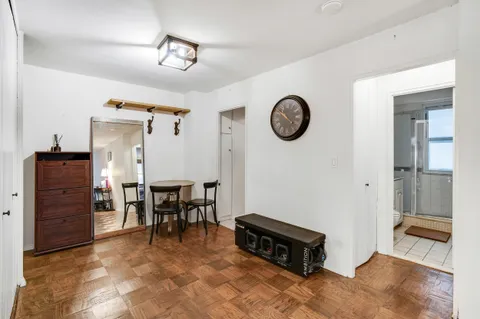 a view of a room with furniture and wooden floor