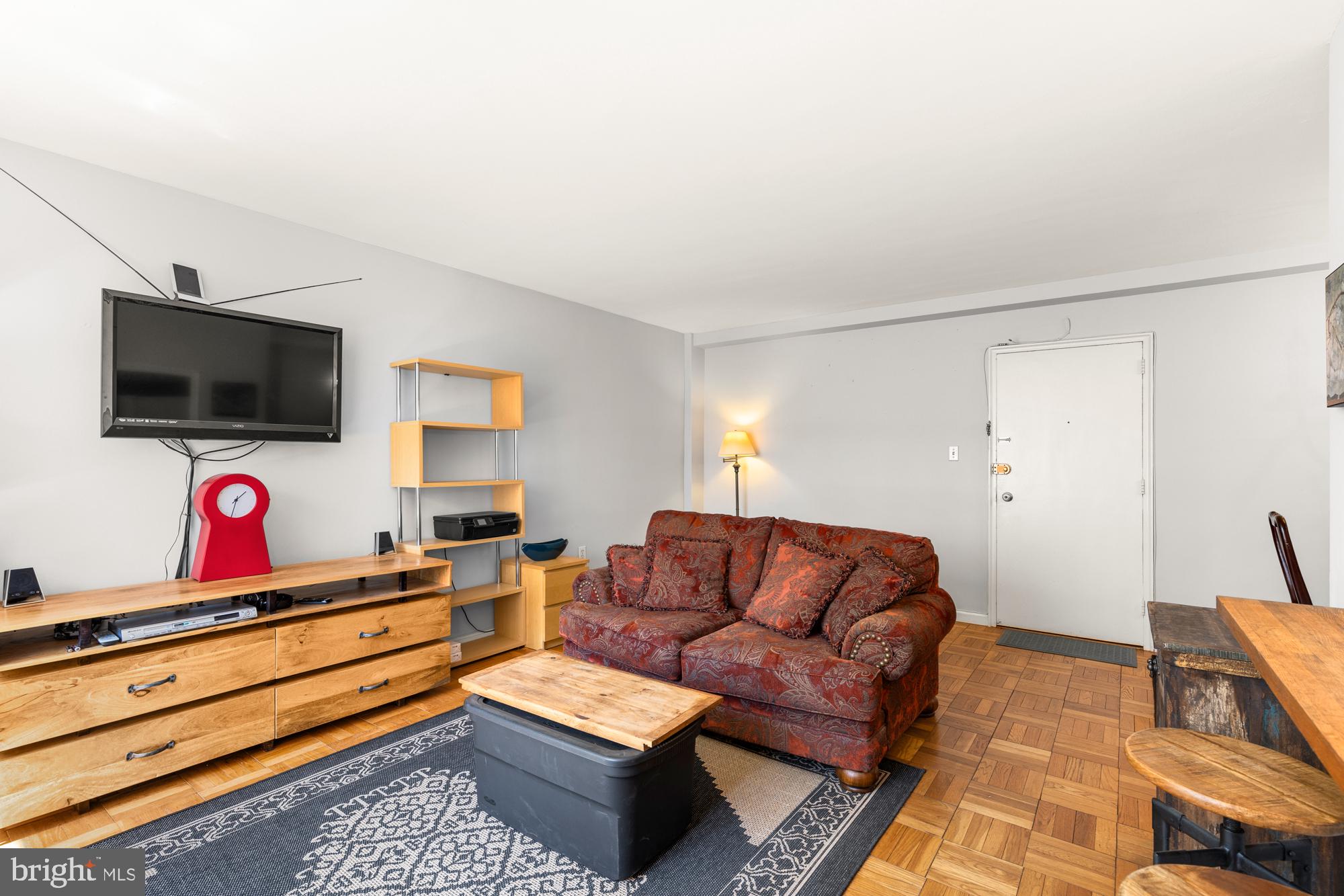 4100 W Street Northwest, Unit 314 Washington, DC 20007 - Photo 6 of 28 a living room with furniture and a flat screen tv