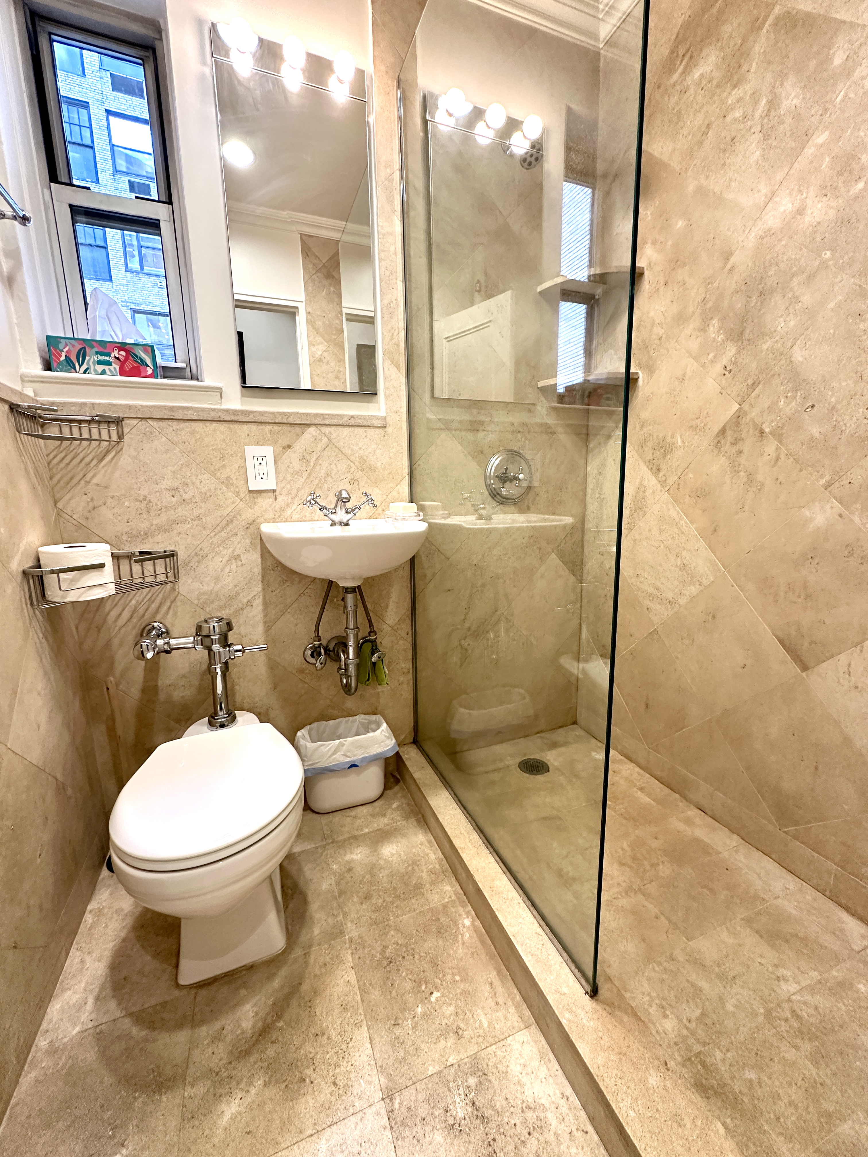 20 East 88th Street, Unit 5B Manhattan, NY 10128 - Photo 4 of 8 a bathroom with a sink toilet and shower