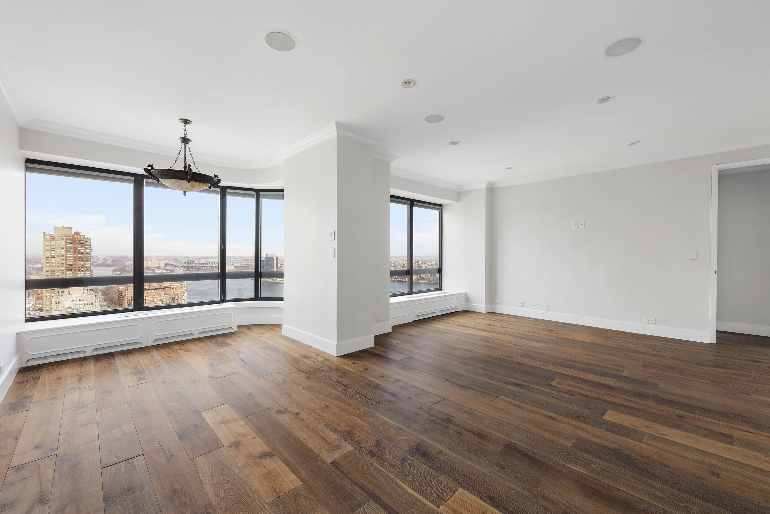 530 East 76th Street, Unit PH36/37E Manhattan, NY 10021 - Photo 12 of 29 a view of an empty room with wooden floor and a window