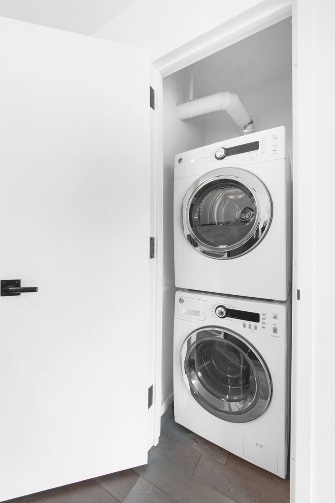 385 1st Avenue, Unit 18G Manhattan, NY 10010 - Photo 7 of 20 a utility room with dryer and washer
