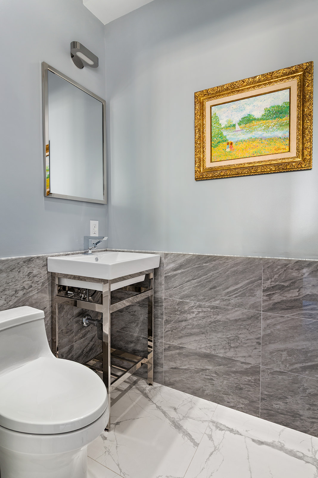 165 East 72nd Street, Unit 17L Manhattan, NY 10021 - Photo 11 of 12 a bathroom with a toilet sink and mirror