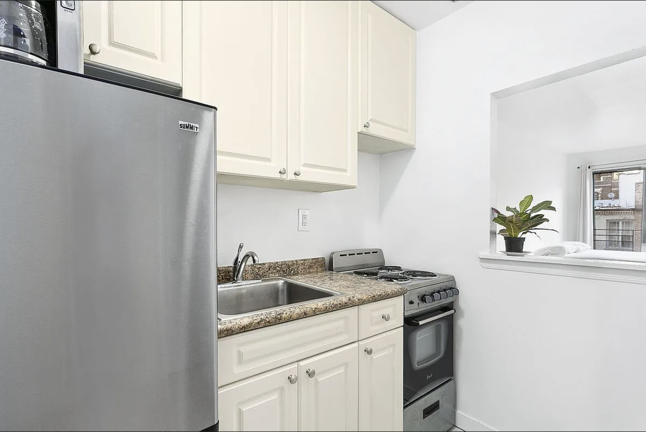 343 East 76th Street, Unit 5D Manhattan, NY 10021 - Photo 5 of 7 a kitchen with stainless steel appliances granite countertop a sink stove and cabinets