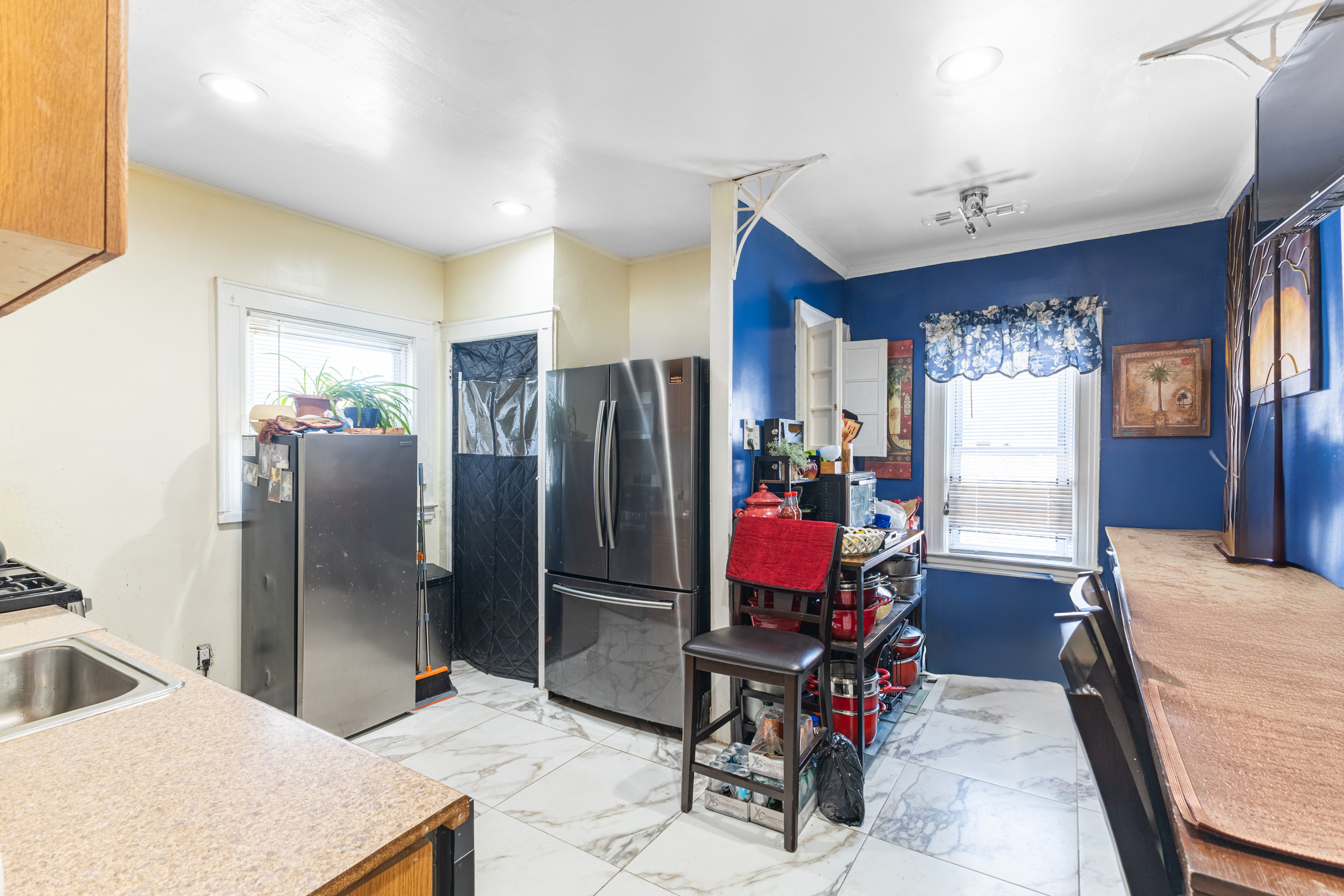 961 East 32nd Street Brooklyn, NY 11210 - Photo 16 of 24 a living room with furniture a chandelier and a dining table