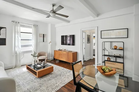 a living room with furniture and wooden floor