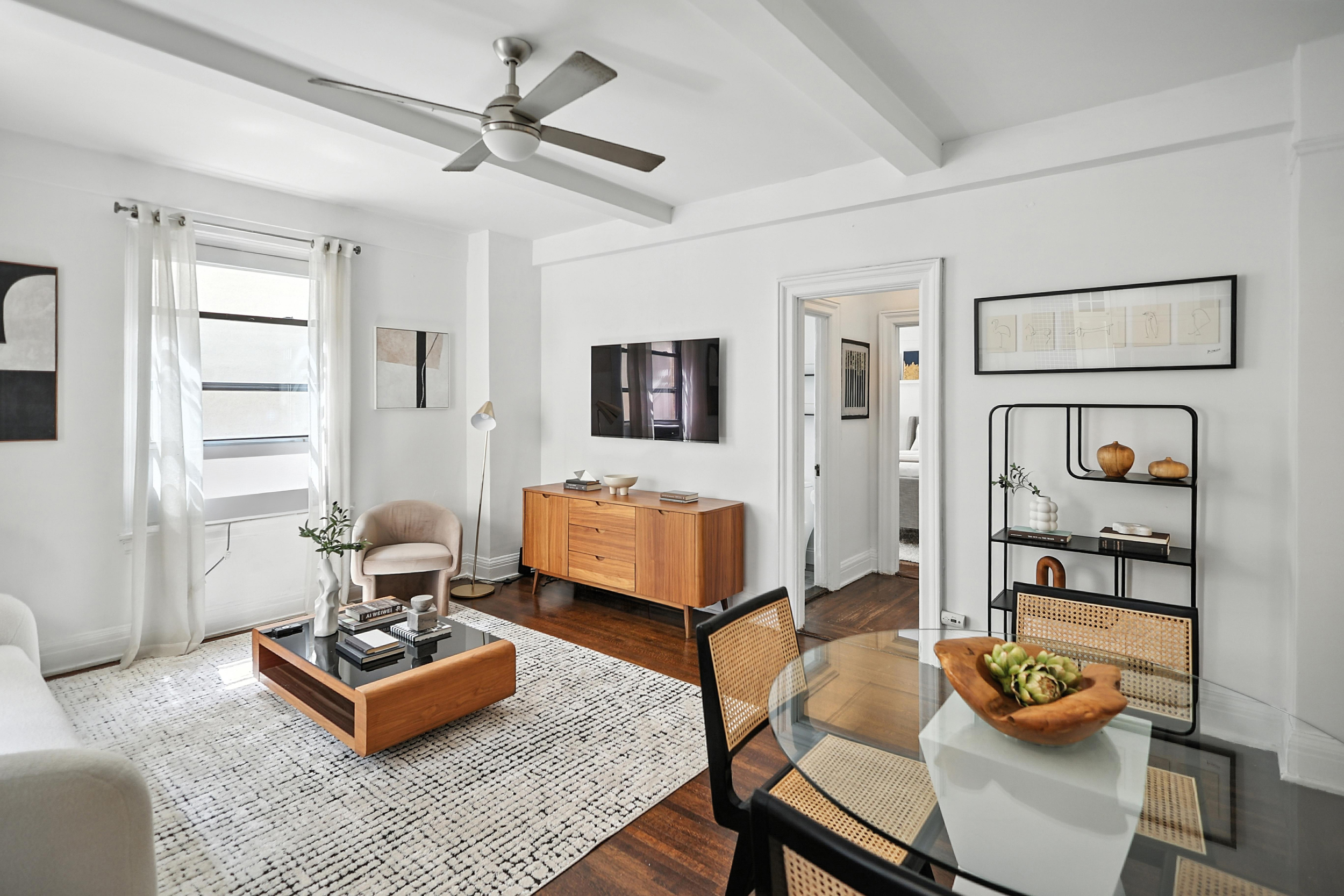 215 West 75th Street, Unit 6B Manhattan, NY 10023 - Photo 3 of 12 a living room with furniture and wooden floor