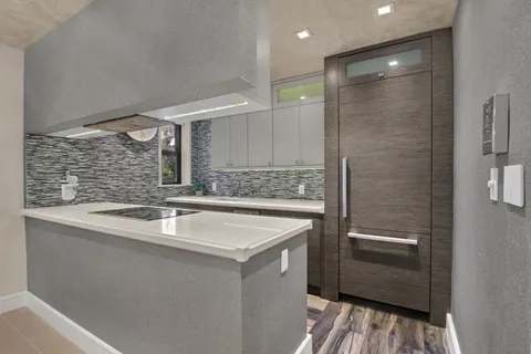 a kitchen with a sink and a refrigerator